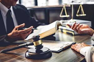 lawful-client-meeting-with-lawyer-in-office-scales-of-justice-thumbnail